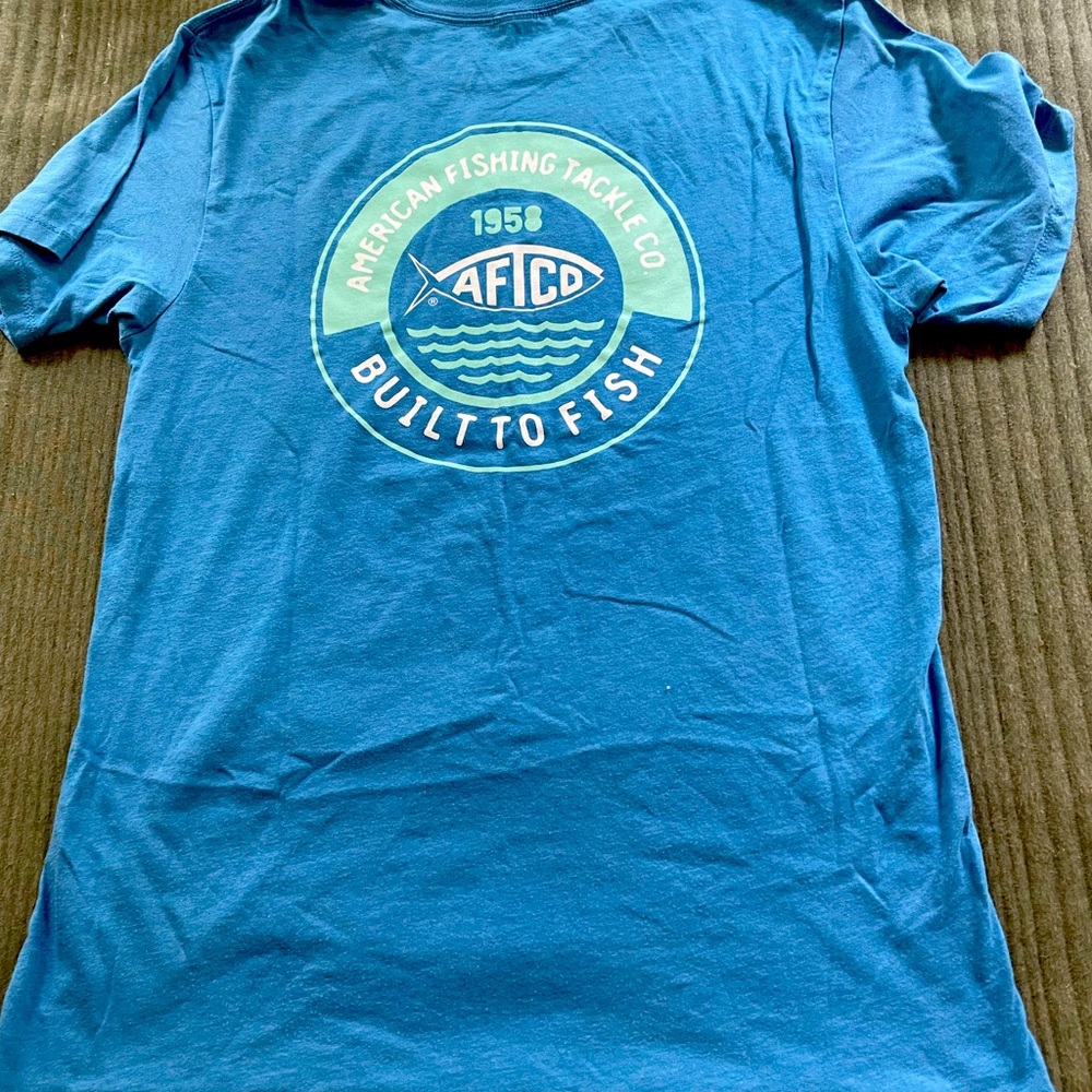 light blue aftico t-shirt with teal design on the back